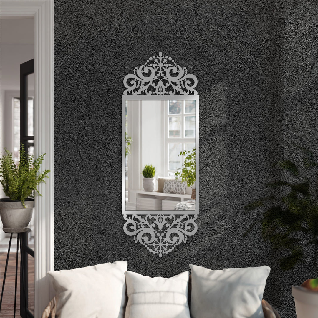 The stillness reflected in the mirror for wall decor showcases the ornate baroque scroll frame, radiating a sense of calm within the elegant black metal design.