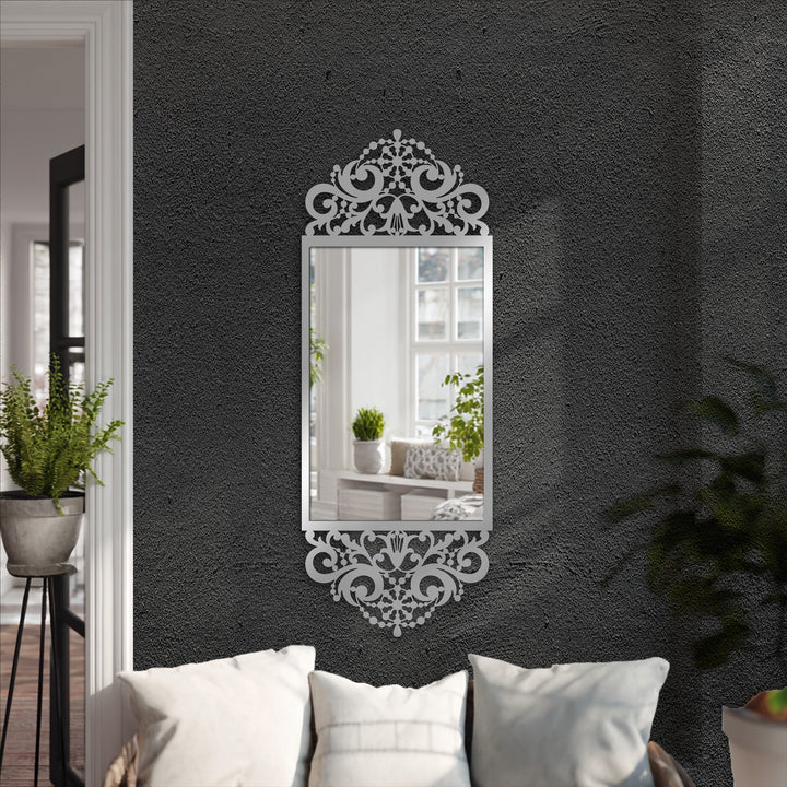 The stillness reflected in the mirror for wall decor showcases the ornate baroque scroll frame, radiating a sense of calm within the elegant black metal design.