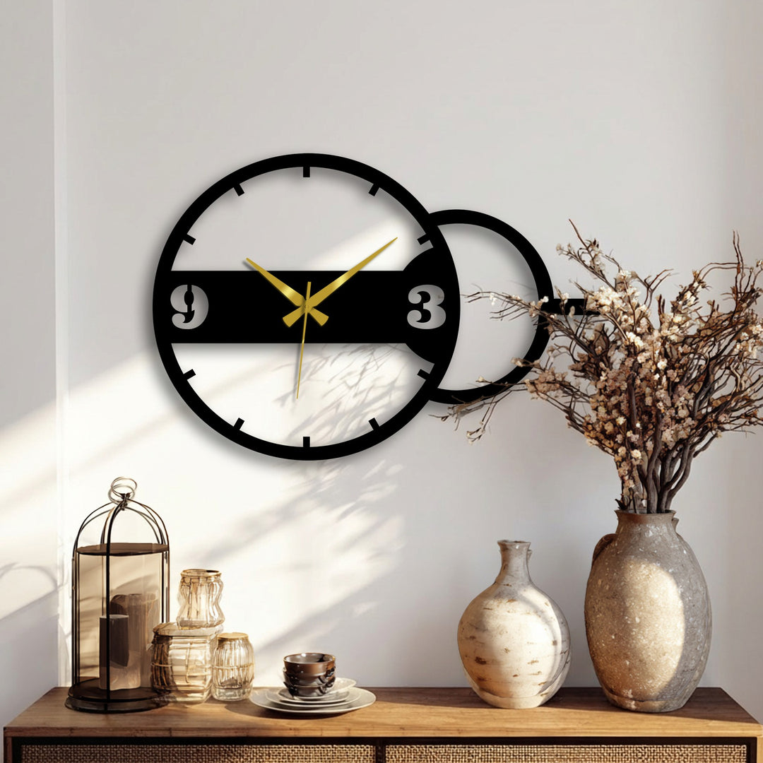 Alternating light and shadow accentuate the geometric dual circle design of this modern metal wall clock, offering a striking example of unique metal wall decor.