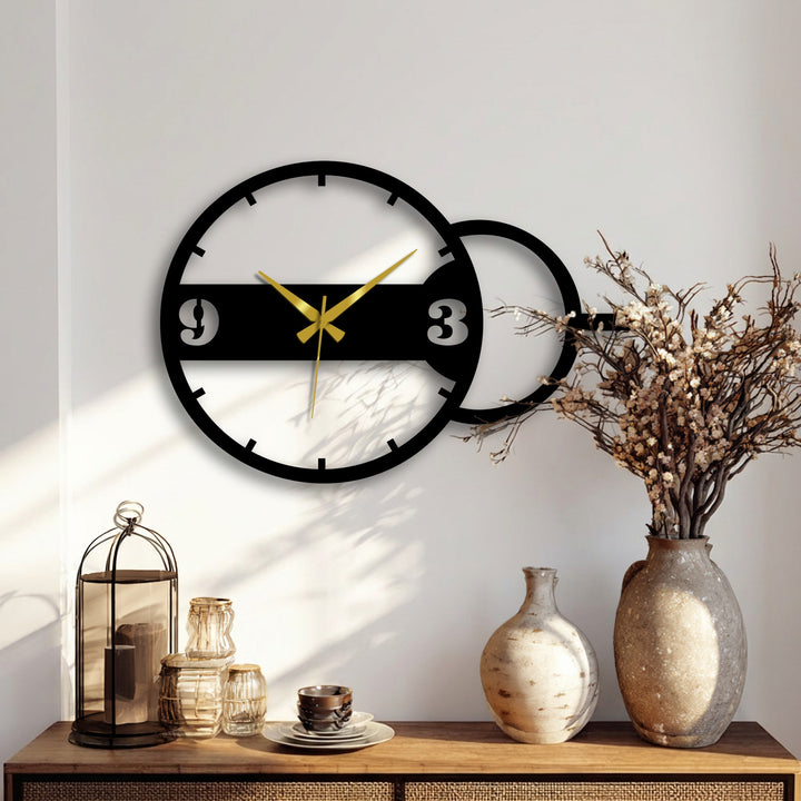 Alternating light and shadow accentuate the geometric dual circle design of this modern metal wall clock, offering a striking example of unique metal wall decor.
