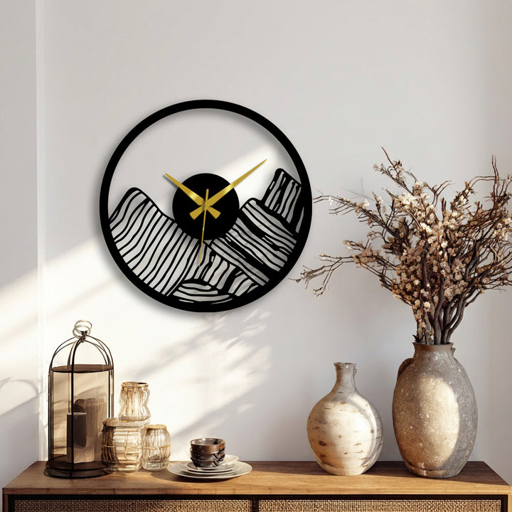 Centered on the wall, a modern canyon landscape metal wall clock, crafted in black metal art for wall, presents gold hands against an abstract mountain design.
