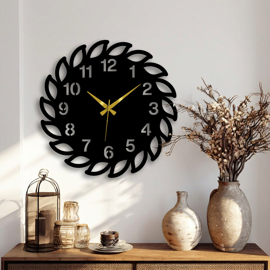 A decorative leaf frame metal wall clock showcasing intricate metal art for wall detail forms the central focal point on a bright wall above a wooden table.
