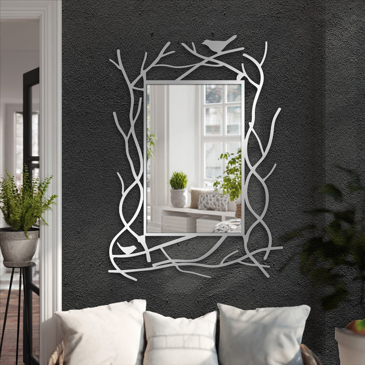 Visual rhythm is created by the repeating branch-like pattern on this nature-inspired metal frame surrounding a stylish rectangular modern wall mirrors.