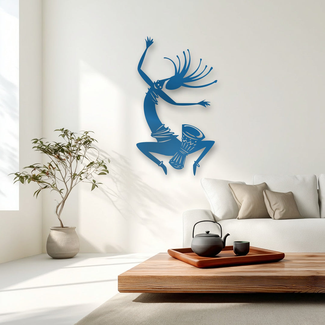 The realistic detail of the deep blue tribal dancer metal artwork highlights an energetic silhouette performing with a drum.