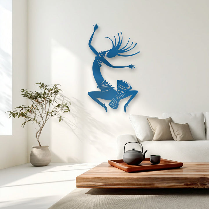 The realistic detail of the deep blue tribal dancer metal artwork highlights an energetic silhouette performing with a drum.