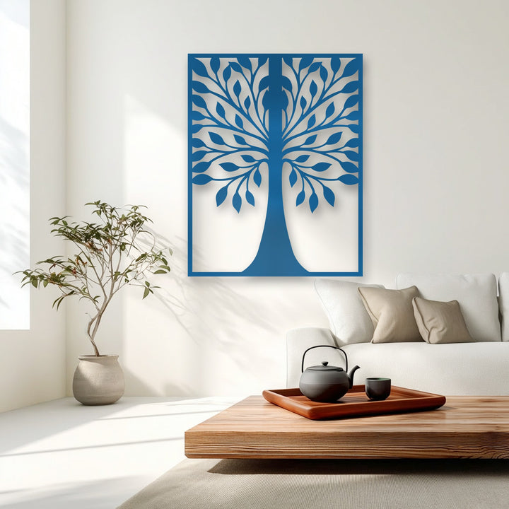 The brightest pristine white wall showcases a vibrant blue symmetrical leaf tree silhouette metal wall decor, highlighted by subtle window shadows.