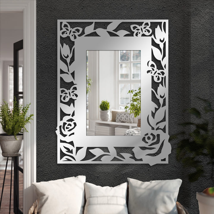 Inviting and sophisticated, this decorative metal art mirror, featuring a floral butterfly frame, creates an elegant and nature-inspired mood for any stylish living space.
