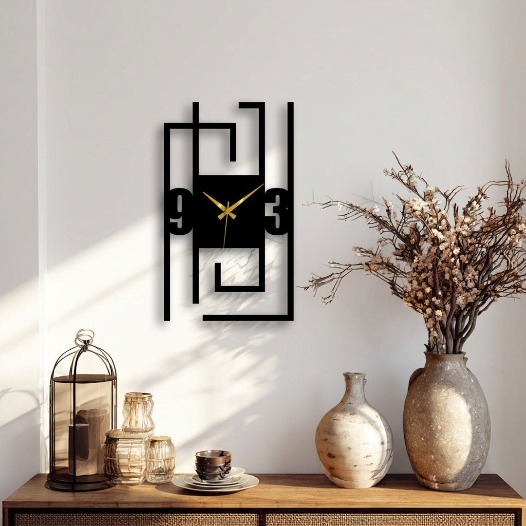 Foreground detail shows decorative objects complementing the modern numeric metal art for wall clock with its abstract line frame.