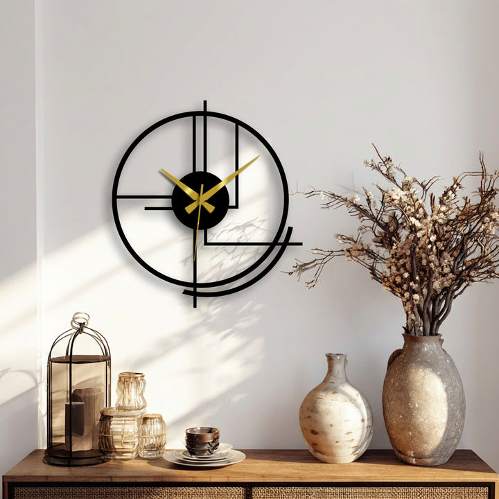 Smooth surface texture highlights the abstract lines of the modern circular metal art for wall clock, with contrasting matte and reflective sheens.