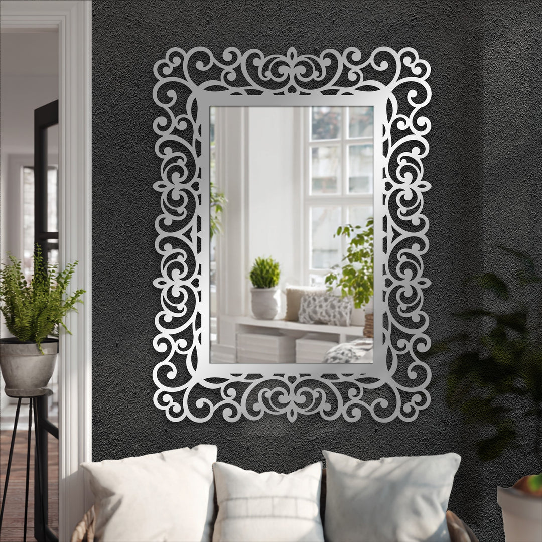 Geometric baroque scrolls and symmetrical rectangles create an eye-catching ornamental frame for this elegant stained glass wall mirror.