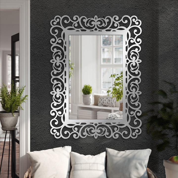 Geometric baroque scrolls and symmetrical rectangles create an eye-catching ornamental frame for this elegant stained glass wall mirror.