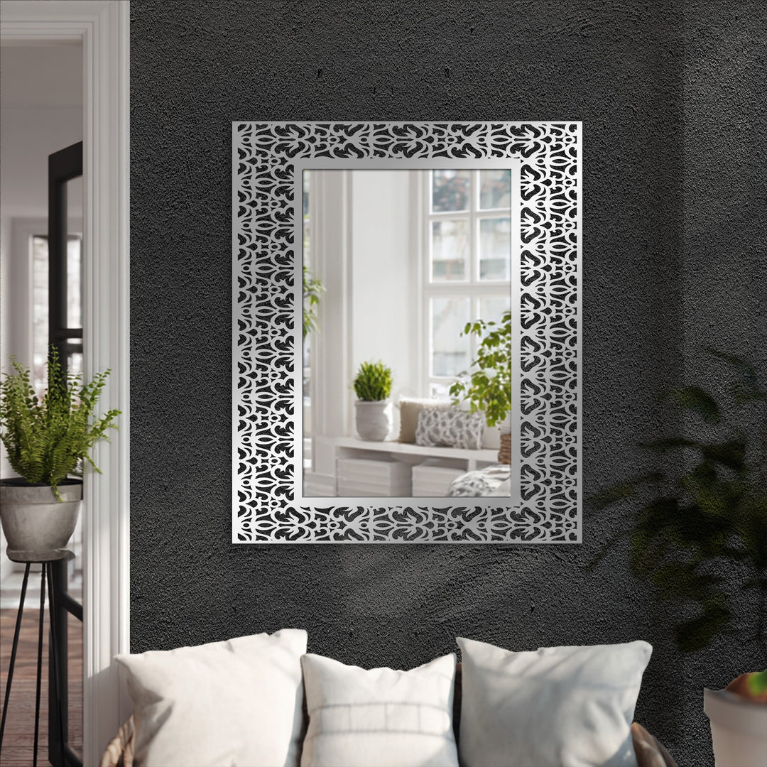 Contrasting dark gray walls and bright white pillows highlight the sleek black metal design of the ornamental damask pattern framed decoration wall art.