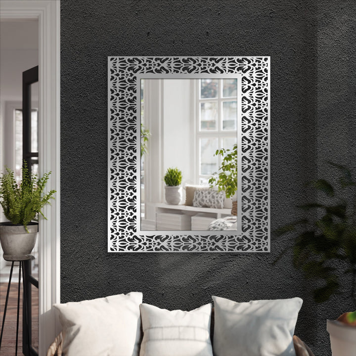 Contrasting dark gray walls and bright white pillows highlight the sleek black metal design of the ornamental damask pattern framed decoration wall art.