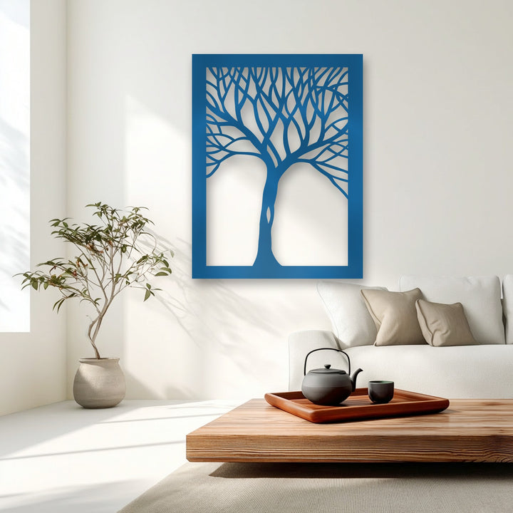 Plush, inviting beige sofa cushions provide a gentle counterpoint to the bold, minimalist abstract tree silhouette metal artwork.