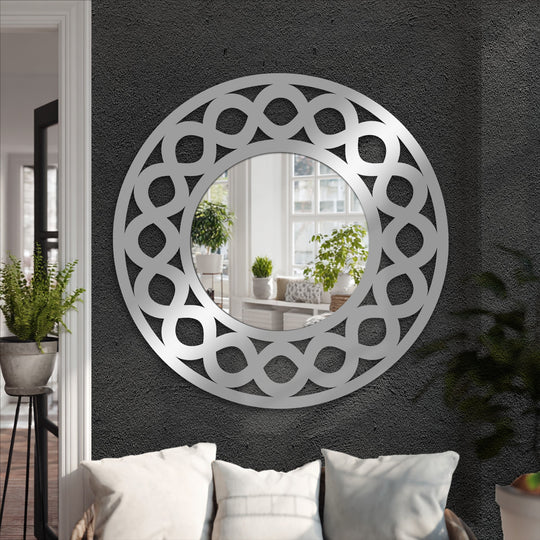 Textured gray wall provides a sophisticated backdrop for the infinity loop round decorative wall mirror, enhancing its modern metal wall decor appeal.