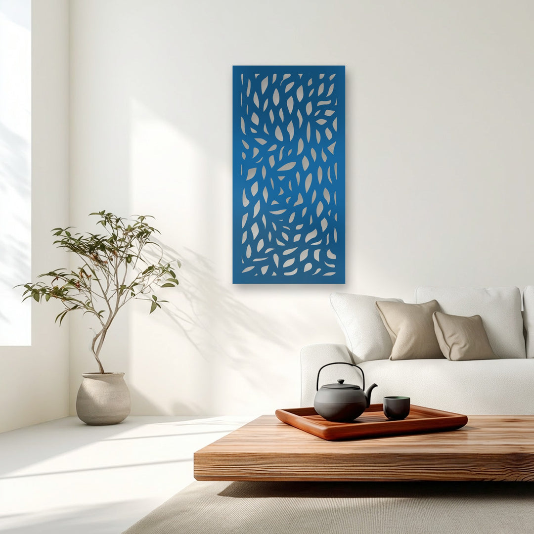 Visual rhythm is evident in the dynamic scattering of stylized leaf cutouts across the vibrant navy blue metal artwork, adding nature-inspired elegance.