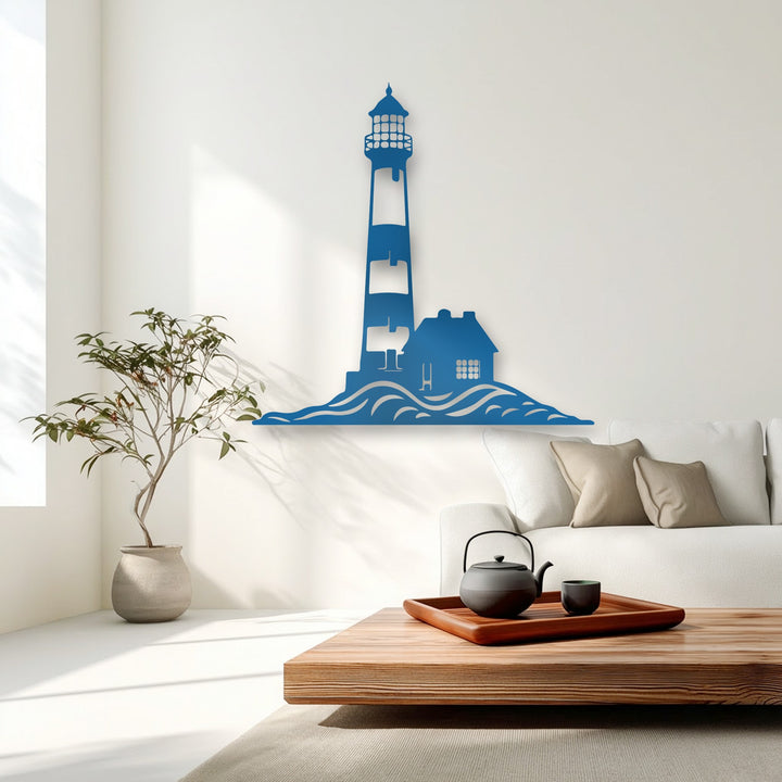 Bright, sun-warmed lighting highlights the elegant cerulean Coastal Lighthouse Silhouette decorative metal art against the luminous white wall.