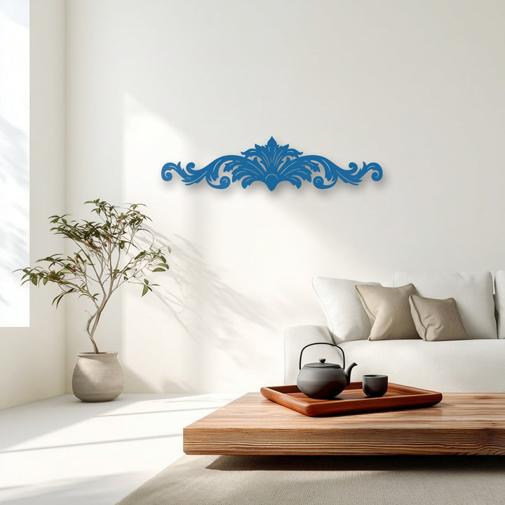 The brightest area, a sun-drenched white wall, beautifully highlights a vibrant blue ornamental scroll metal wall decor.