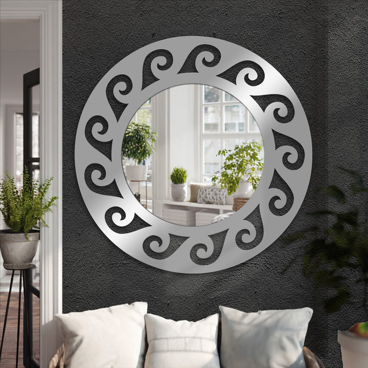 The organic forms of this round mirror showcase a swirling pattern, adding an artistic touch and making it a unique modern wall mirrors focal point.