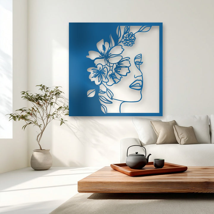 The exceptional material quality of this unique metal wall art highlights its sleek lines and bold blue floral woman profile.