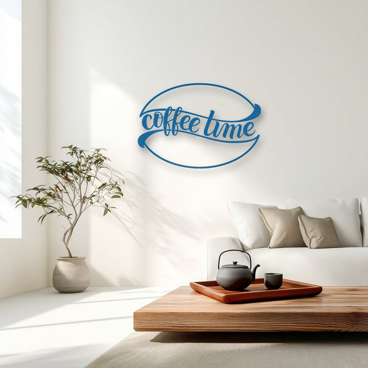 The brightly lit white wall highlights the elegant blue 'Coffee Time' metal wall decor, creating a striking focal point in the room.