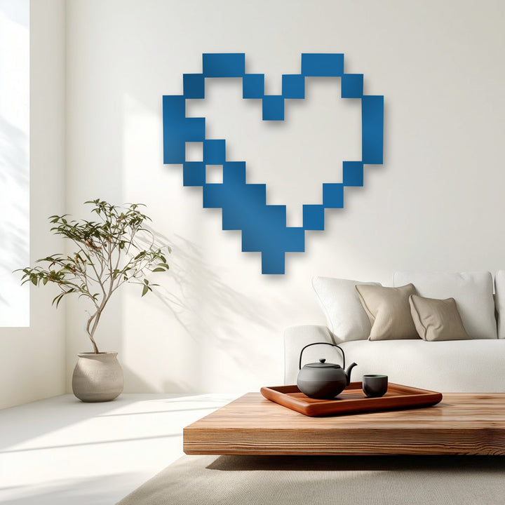 The matte finish of this vibrant blue pixel heart unique metal wall art stands out against a white wall.