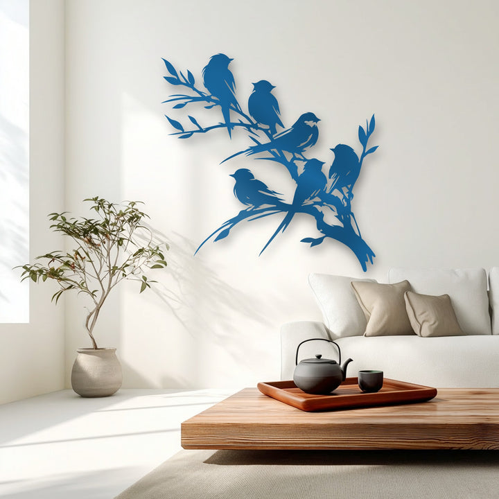 Organic forms of deep blue decorative metal art depict birds perched on flowing branches, creating a harmonious silhouette.