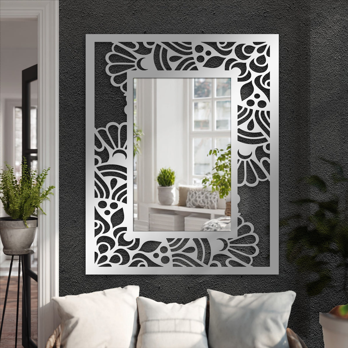 Botanical-patterned edge details adorn this modern mirror for wall decor, creating a unique abstract floral frame around the reflective surface.