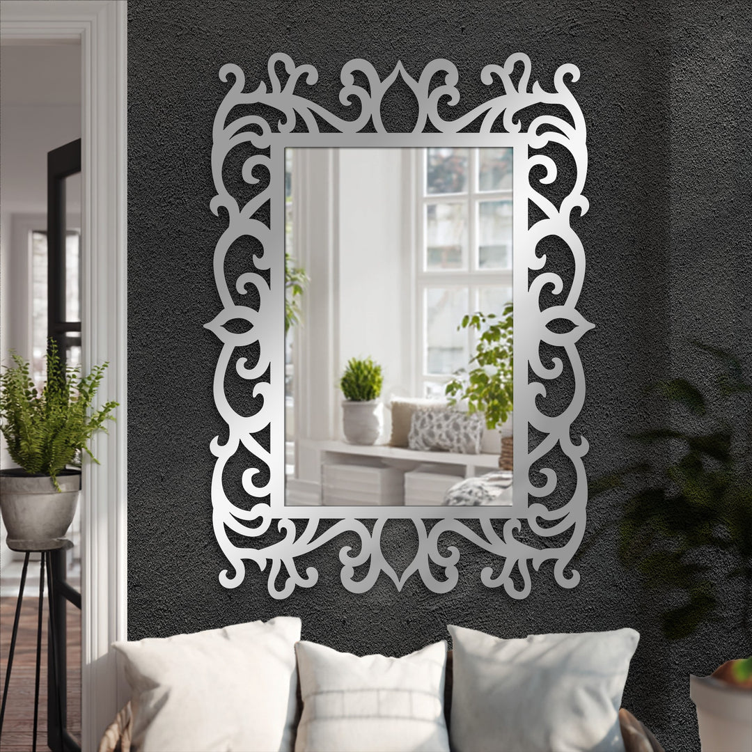 Elegant black metal finish enhances the ornate floral scroll frame floor mirror, creating a striking piece of unique metal wall art.