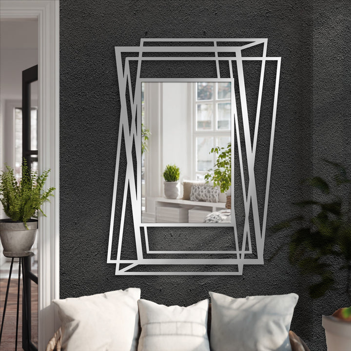 Soft, inviting throw pillows rest in the foreground below a multi-layer abstract geometric frame floor mirror, offering ideas for decorating with wall mirrors in a modern living space.