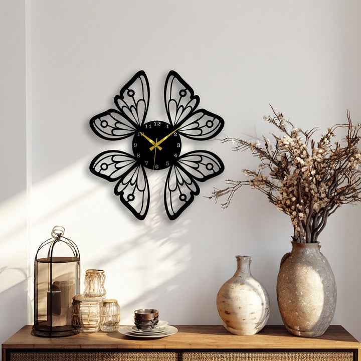 A striking black butterfly wings wall clock serves as unique metal wall art, featuring a nature-inspired decorative design with golden hands.