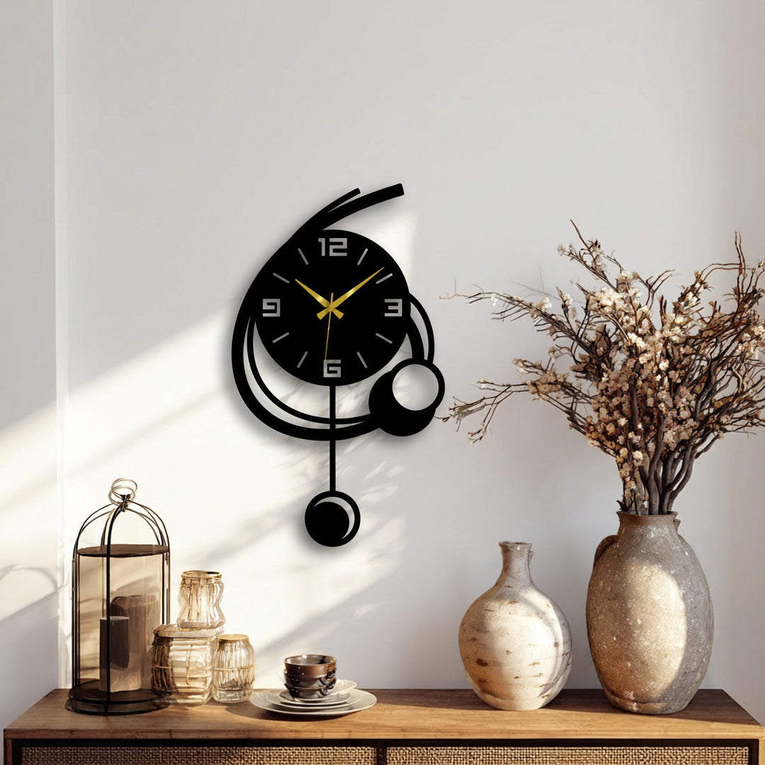 Sunlight highlights the modern orbit design of this metal art for wall clock, illuminating its minimalist geometric decor with golden hands.