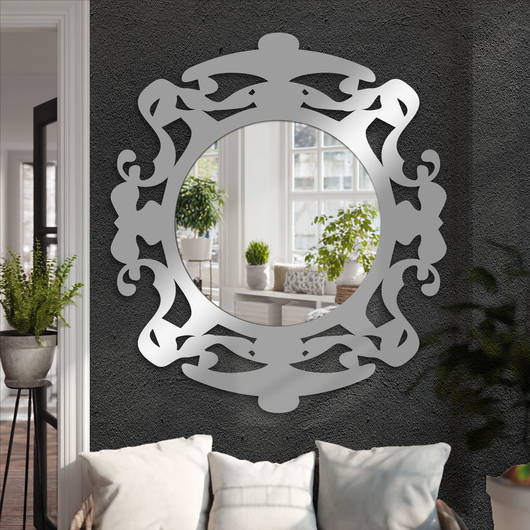 The layering effect of the ornate black metal art for wall frame enhances the round mirror's intricate design, reflecting a bright room.