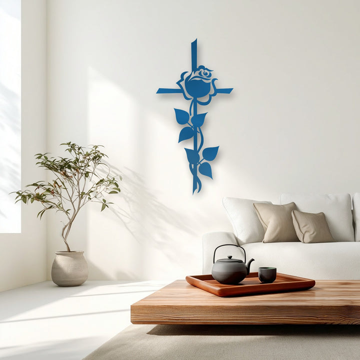 Strong shadows from a window and the azure decorative metal art rose cross silhouette create depth on a sunlit white wall.