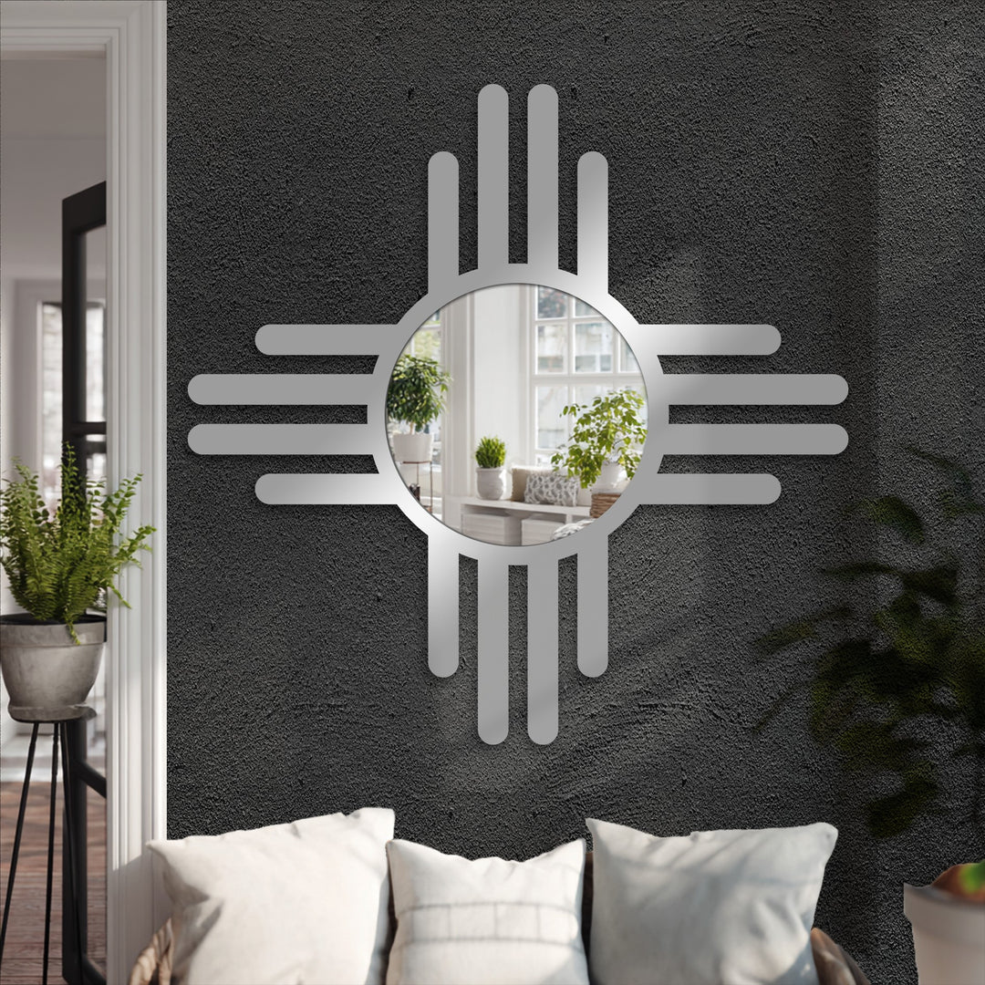 Soft throw pillows introduce a welcoming contrast to the contemporary bathroom mirror, accentuating the modern cross line design with subtle home decoration.