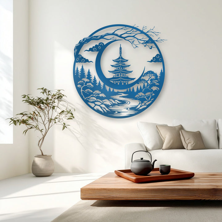 The prominent azure metal art for wall showcases a serene Japanese pagoda nestled within a crescent moon landscape, surrounded by trees and clouds.