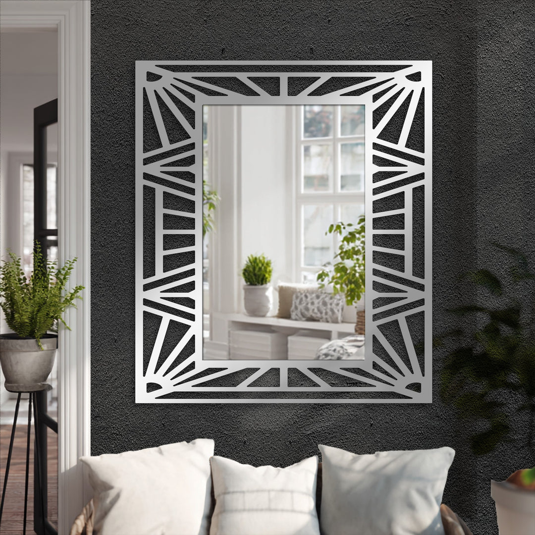 Stark color contrast accentuates the black metal lines of the geometric sunburst frame in this striking decorative mirror.
