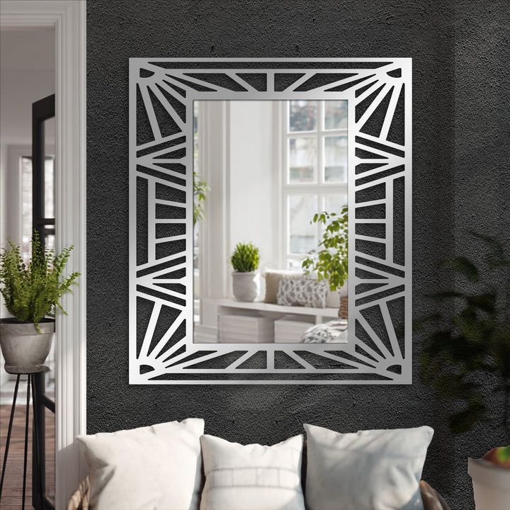 Stark color contrast accentuates the black metal lines of the geometric sunburst frame in this striking decorative mirror.
