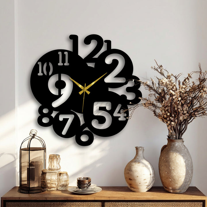 Visual rhythm is created by the overlapping numbers in this modern metal wall clock, offering a unique metal wall art piece with its bold, contemporary design.