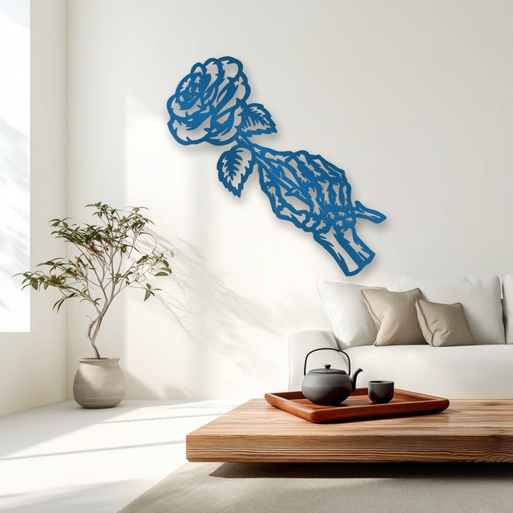 The stillness of the room is captured by the deep blue gothic rose skeleton metal artwork on the pristine white wall.