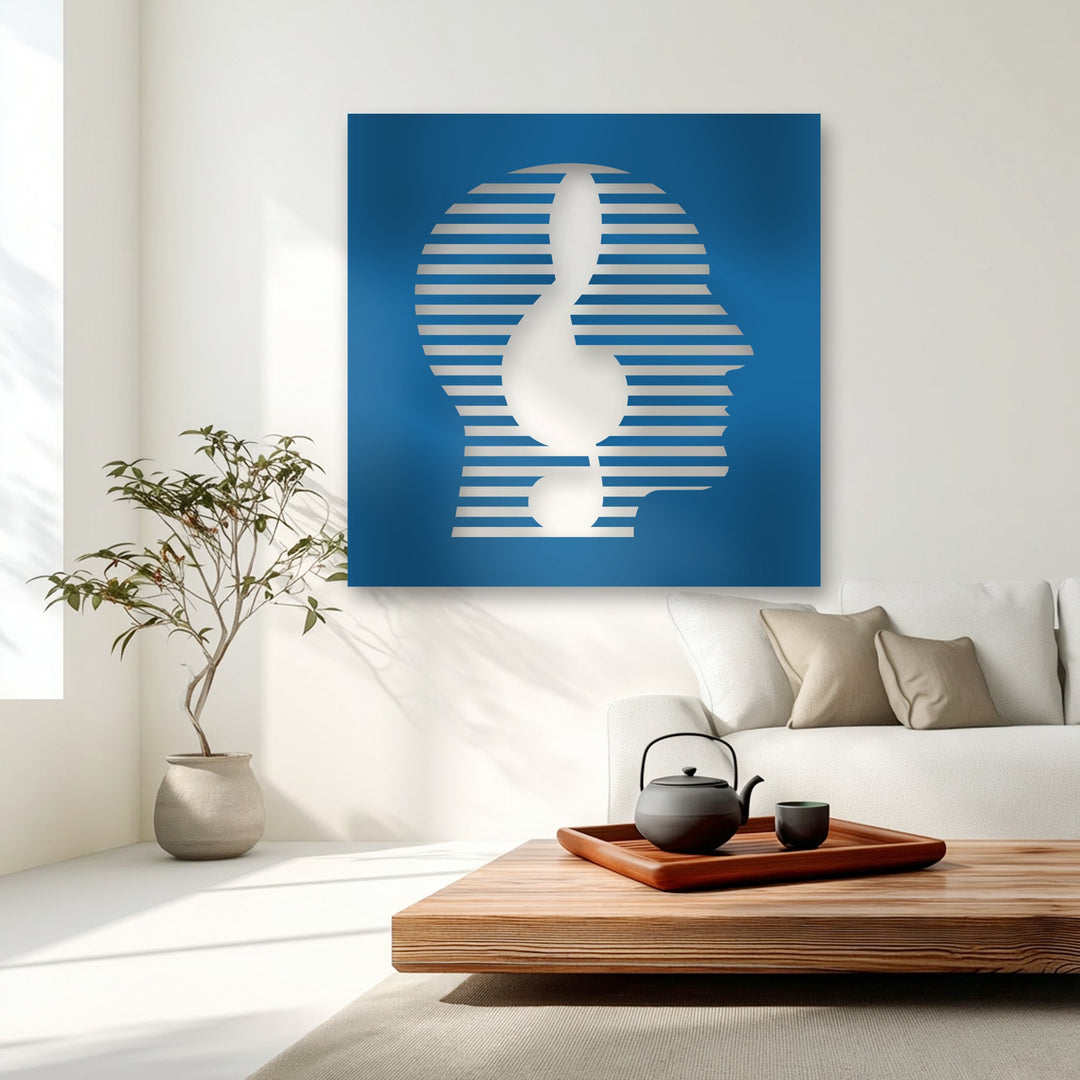 The vivid transition from deep blue to light-toned horizontal stripes creates a striking abstract face and exclamation mark in this modern decorative metal art.