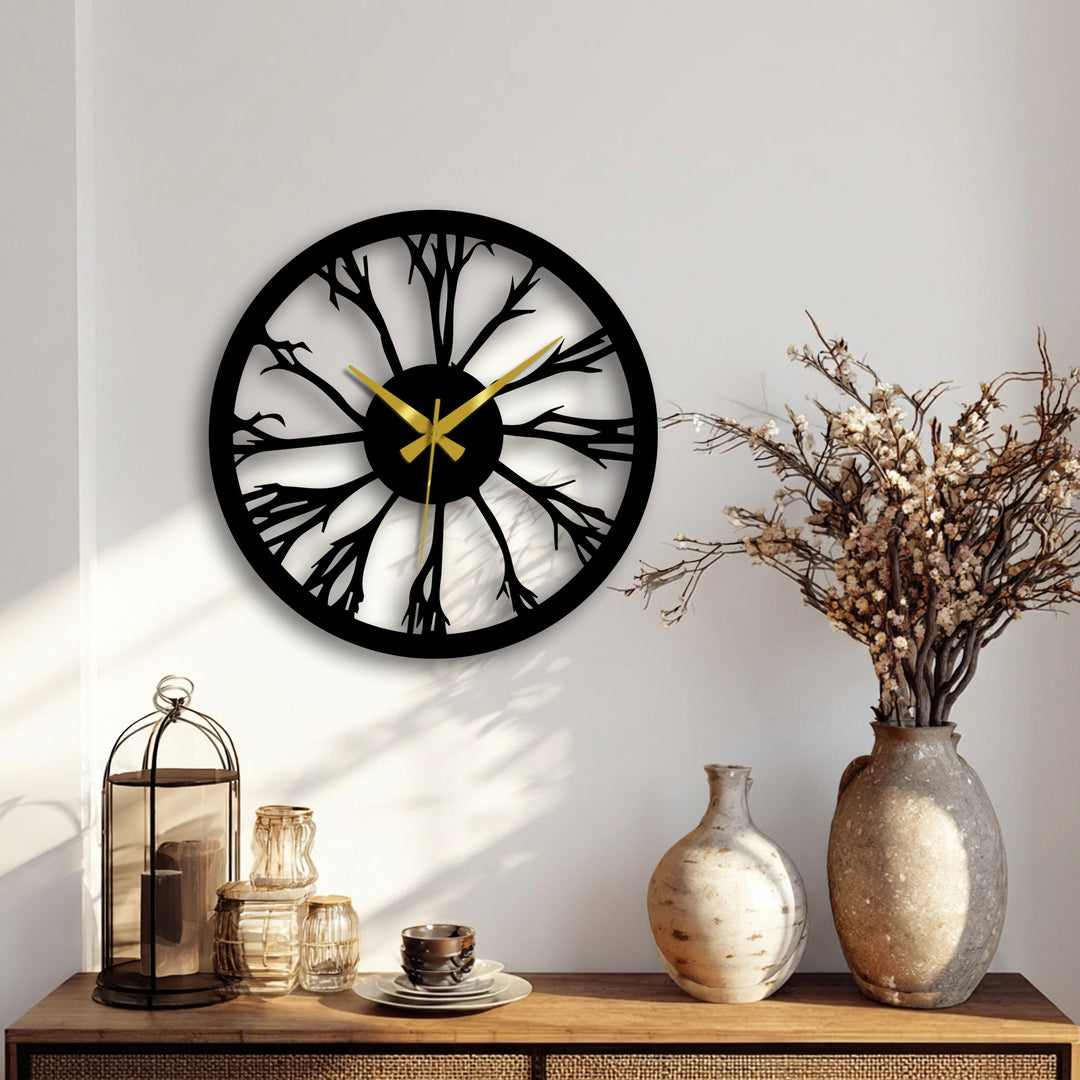 Highlighting the transition between colors, this nature-inspired tree silhouette metal art for wall clock features golden hands against a black metal design.