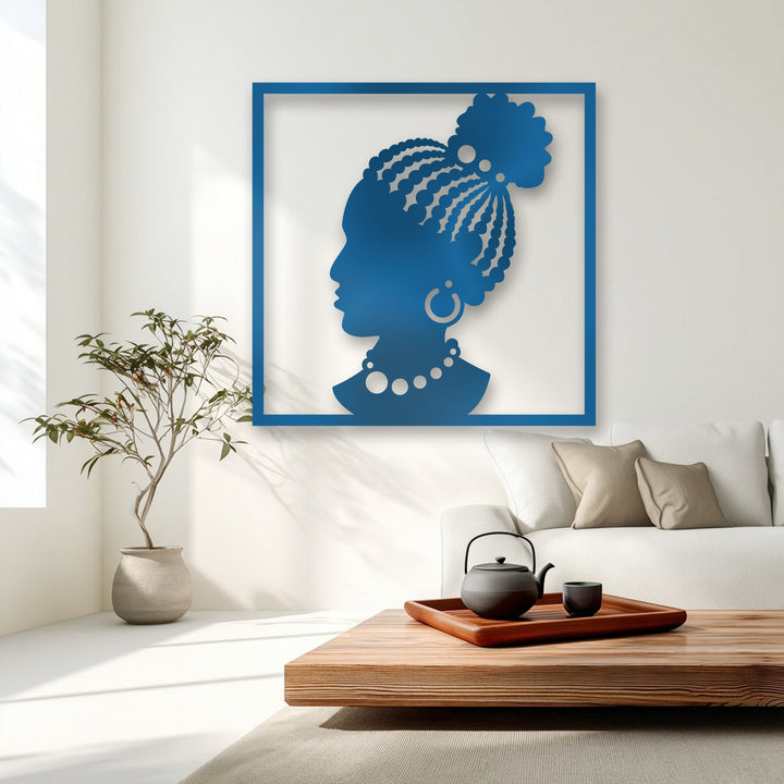 Dynamic sunlit shadows gracefully move across the vibrant blue African woman metal wall decor, accentuating her intricate braided hair and elegant jewelry.