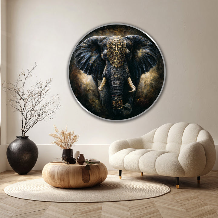 Featuring rich color saturation, this round wood oil painting home decor piece depicts a royal guardian elephant, its dark, majestic presence accentuated by a golden tribal mask.