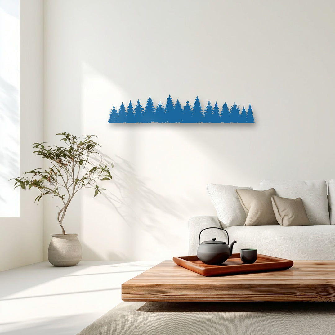 Crisp shadows from morning light play on the white wall, emphasizing the blue pine forest silhouette decorative metal art.