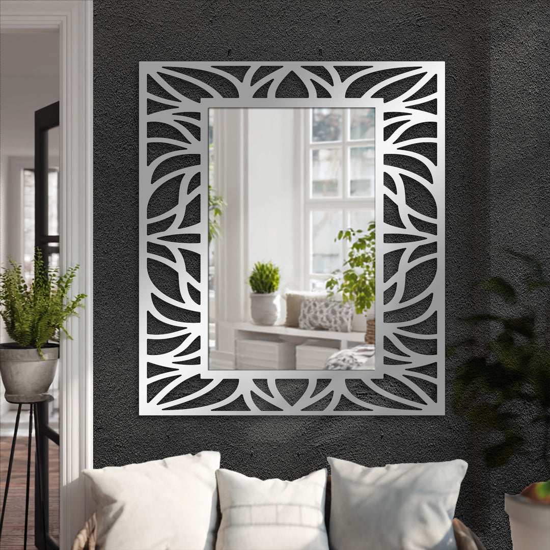 Focal point is on the organic leaf patterned frame surrounding the mirror for wall decor, showcasing the modern floor mirror's black metal design.