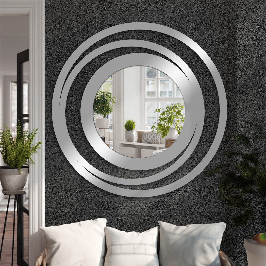 Outlining the round Orbit Ring floor mirror, its layered silver-tone edges offer a chic approach to decorating with wall mirrors, enhancing modern home decor.