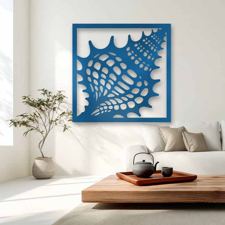 A vibrant deep blue matte finish characterizes the decorative metal art, showcasing its intricate perforated seashell texture.