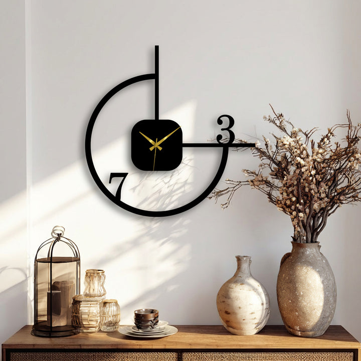 Warm color temperature highlights the black metal artwork of this minimalist geometric wall clock, adding a modern, abstract touch to the interior.