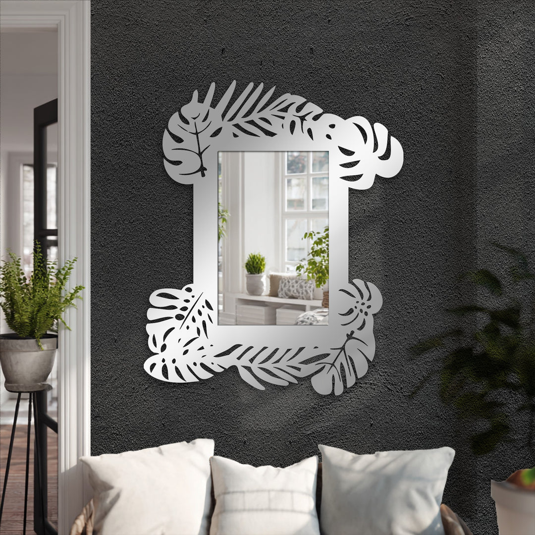Textured dark gray decoration wall art background showcases a tropical leaf frame metal wall mirror with a botanical statement design.